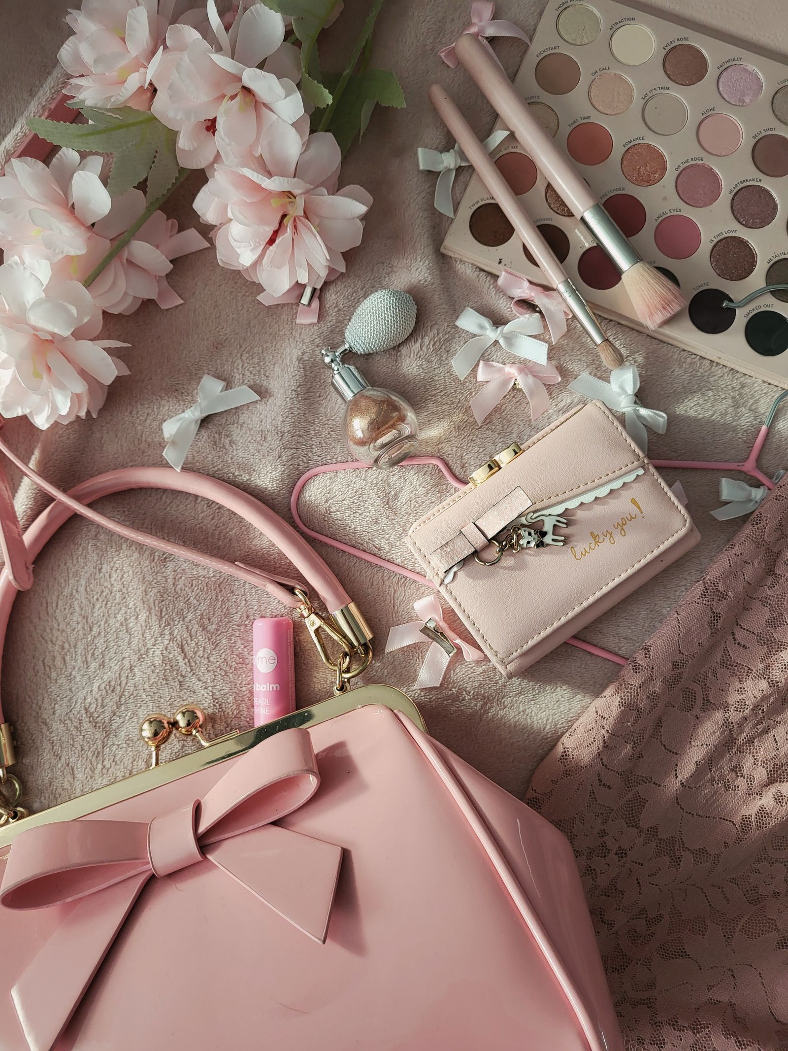 Makeup brushes and a soft eyeshadow palette arranged for an eye makeup look