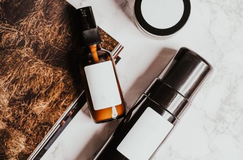 A compact selection of skincare products on a pale marble surface