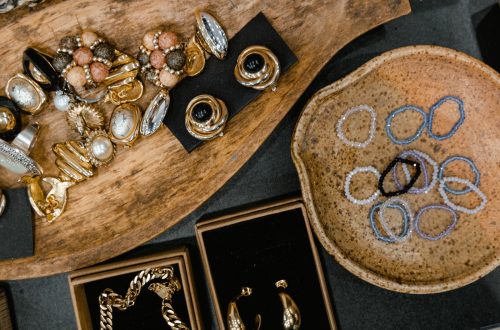 Everyday earrings, rings, and bracelets arranged on neutral trays