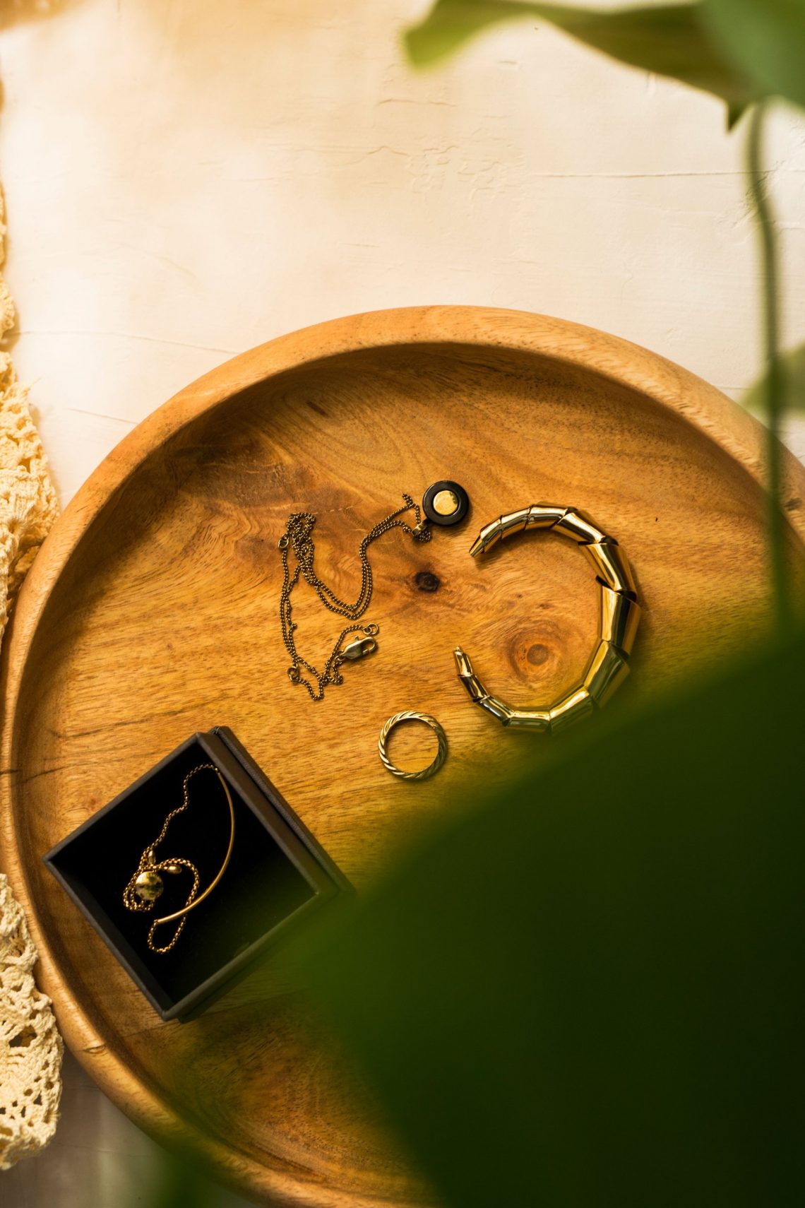 Gold and silver jewelry arranged together on a neutral surface