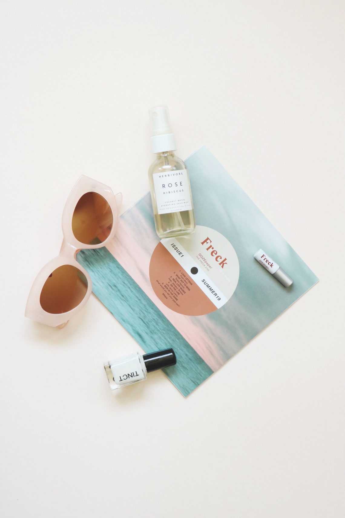 Sunglasses and skincare products arranged for a summer day