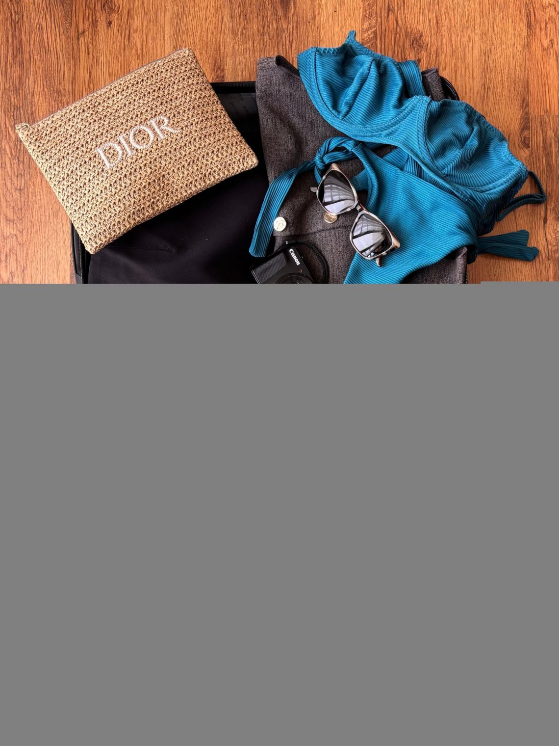 Travel essentials arranged inside an open suitcase